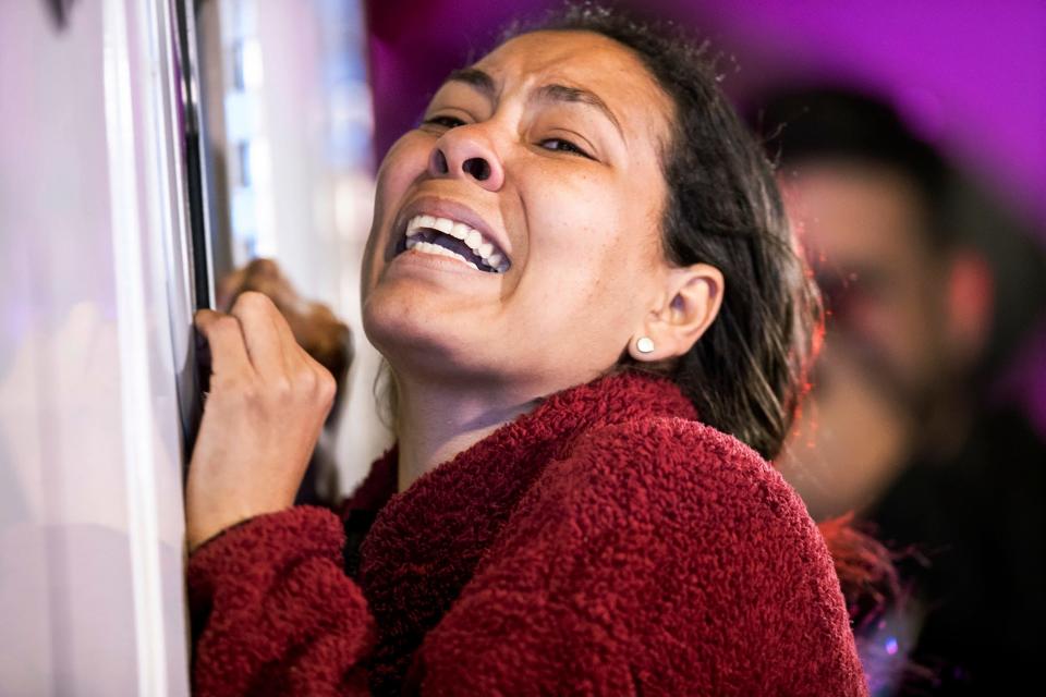 A woman cries as a person she knows is attended to by medics after a fire at a Mexican immigration detention center in Ciudad Juarez.