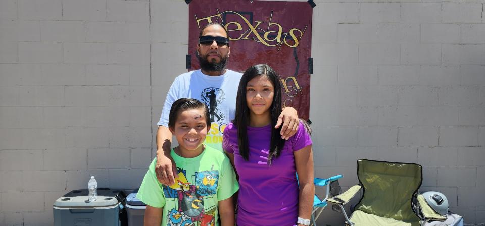 Eric Frausto stands with his son Nicasio and daughter Jessalynne Saturday during the Texas Chozen car wash, held  at 4210 SW 45th Ave. to raise funds for medical expenses the family incurred after a road rage shooting.
