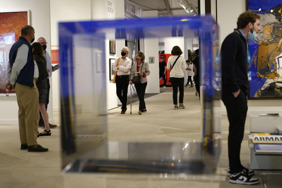 A sculpture titled Blue Cube by artist Jesus Rafael Soto is displayed by the Ascaso Gallery at Art Miami during Miami Art Week, Wednesday, Dec. 1, 2021, in Miami. Miami Art Week is an annual event centered around the Art Basel Miami Beach fair. (AP Photo/Lynne Sladky)