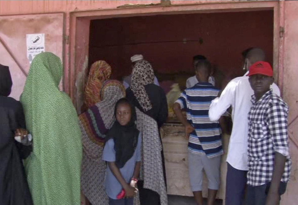 In this frame grab from video, people wait in line for bread outside a bakery in Khartoum, Sudan, Sunday, June 9, 2019. The first day of the workweek in Sudan saw shops closed and streets empty as part of a general strike called by protest leaders who are demanding the resignation of the ruling military council. The Sudanese Professionals Association had urged people to stay home to protest a deadly crackdown last week, when security forces violently dispersed the group’s main sit-in camp outside the military headquarters in the capital of Khartoum. (AP Photo)