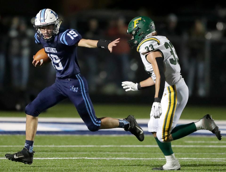 Little Chute's Charlie VandenBurgt (19) scrambles against Freedom's Levi Baumgart during their game last season in Little Chute.