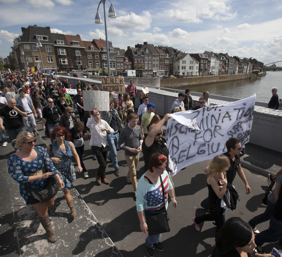 Demonstrators carry a banner reading "no discrimination for Belgium" during a protest rally against the new marijuana buying policy in Maastricht, southern Netherlands, Tuesday May 1, 2012. A policy barring foreign tourists from buying marijuana in the Netherlands goes into effect in parts of the country Tuesday, with a protest planned in the southern city of Maastricht. Weed is technically illegal in the Netherlands, but it is sold openly in small amounts in designated cafes under the country's famed tolerance policy. The government has said that as of May 1, only holders of a "weed pass" will be allowed to purchase the drug, and nonresidents aren't eligible. (AP Photo/Peter Dejong)