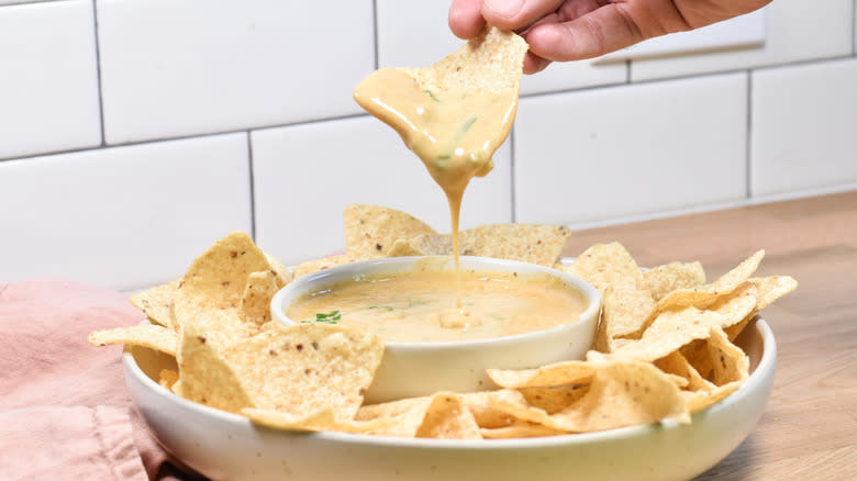 tortilla chip dripping smoky queso