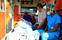 Paramedics assist a Turkish worker injured in an explosion in Afgoye town, before he boards a Turkish military cargo plane at the Aden Abdulle International Airport in Mogadishu