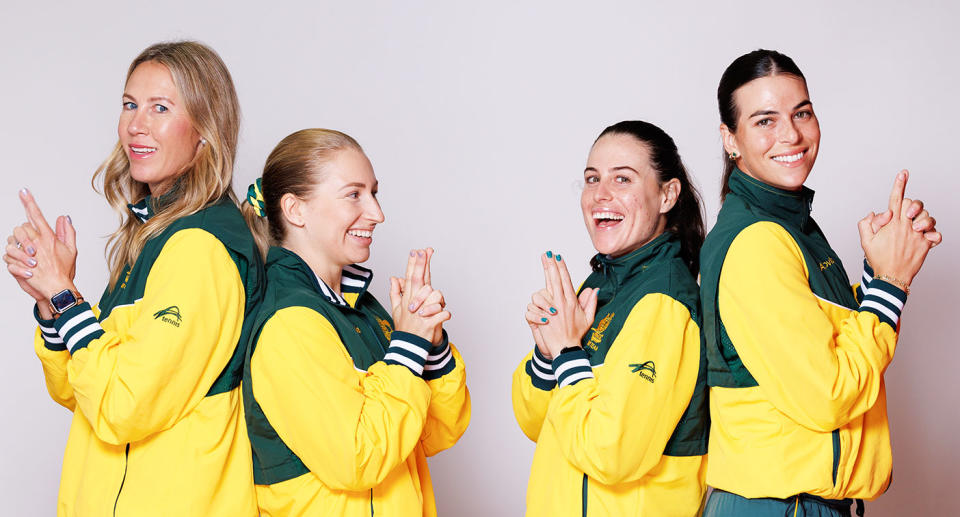 Captain Alicia Molk is seen on the far left posing for a photo with Australia's BJK Cup team.