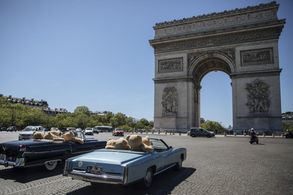 Teddy bears, set up by Philippe Labourel, who wants to be named 'Le papa des nounours' (Teddy Bears father) are pictured inside American vintage cars driving through Paris, Sunday, June, 13, 2021. The event took place in a show of support for the tourism industry which was hit by the COVID-19 pandemic. (AP Photo/Lewis Joly)