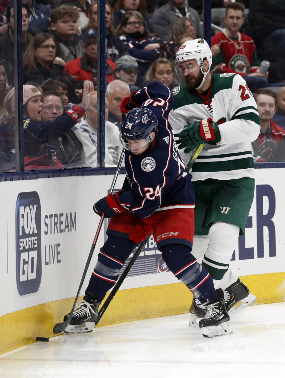 Columbus Blue Jackets forward Nathan Gerbe, left, controls the puck in front of Minnesota Wild defenseman Greg Pateryn during the second period of an NHL hockey game in Columbus, Ohio, Friday, Feb. 28, 2020. (AP Photo/Paul Vernon)