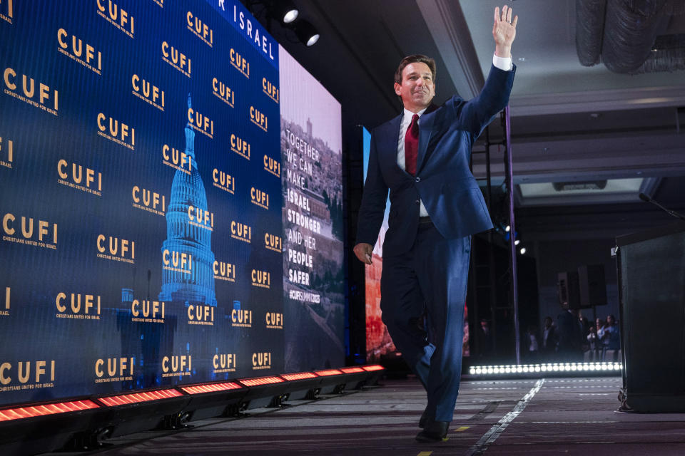 Republican presidential candidate Florida Gov. Ron DeSantis, right, waves as he leaves the stage after speaking to the Christians United For Israel (CUFI) Summit 2023, Monday, July 17, 2023, in Arlington, Va. (AP Photo/Jacquelyn Martin)