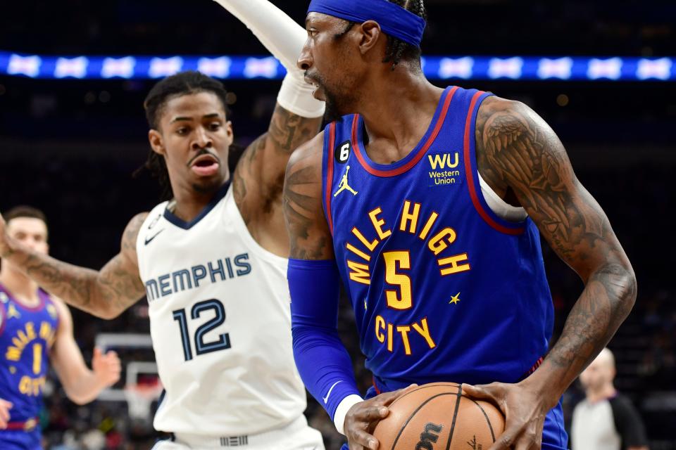 Denver Nuggets guard Kentavious Caldwell-Pope, right, is defended by Memphis Grizzlies guard Ja Morant (12) during the first half of an NBA basketball game Saturday, Feb. 25, 2023, in Memphis, Tenn. (AP Photo/Brandon Dill)