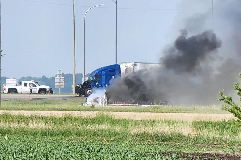 Smoke comes out of a car following a road accident that left 15 dead near Carberry, west of Winnipeg, Canada on June 15, 2023. At least 15 people died June 15, 2023 in a road accident in central Canada's Manitoba province, local media reported. Canadian police said on Twitter that officers were responding to a "mass casualty collision" near the town of Carberry, west of Winnipeg, and that first responders and other Royal Canadian Mounted Police units were on the scene. (Photo by Nirmesh VADERA / AFP) (Photo by NIRMESH VADERA/AFP via Getty Images)