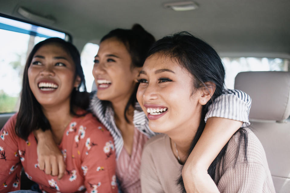 A trio of friends are laughing together