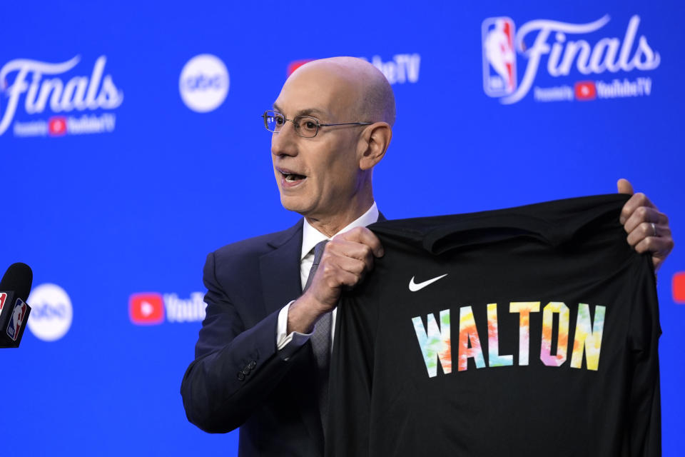 NBA Commissioner Adam Silver displays a warm-up jersey honoring basketball great Bill Walton to be worn during warmups before Game 1 of basketball's NBA Finals between the Boston Celtics and the Dallas Mavericks, Thursday, June 6, 2024, in Boston. (AP Photo/Charles Krupa)