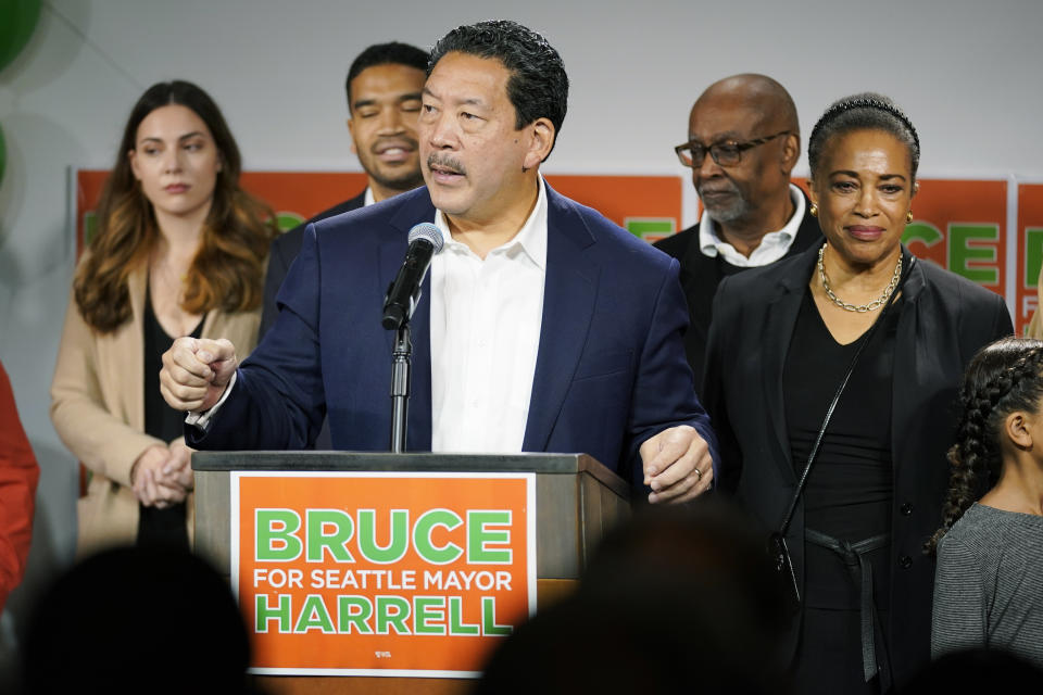 FILE - Seattle Mayor Bruce Harrell, center, talks to supporters at an election night rally, Nov. 2, 2021, in Seattle as his wife, Joanne Harrell, right, looks on. For years, liberal cities in the U.S have tolerated people living in tents in parks and public spaces, but increasingly leaders in places like Portland, Oregon, New York and Seattle are removing encampments and pushing other strict measures that would've been unheard of a few years ago. Harrell ran on a platform that called for action on encampments and the city has focused on certain highly visible tent cities in his first few months in office. Across from City Hall, two blocks worth of tents and belongings were removed Wednesday, March 9, 2022. (AP Photo/Ted S. Warren, File)