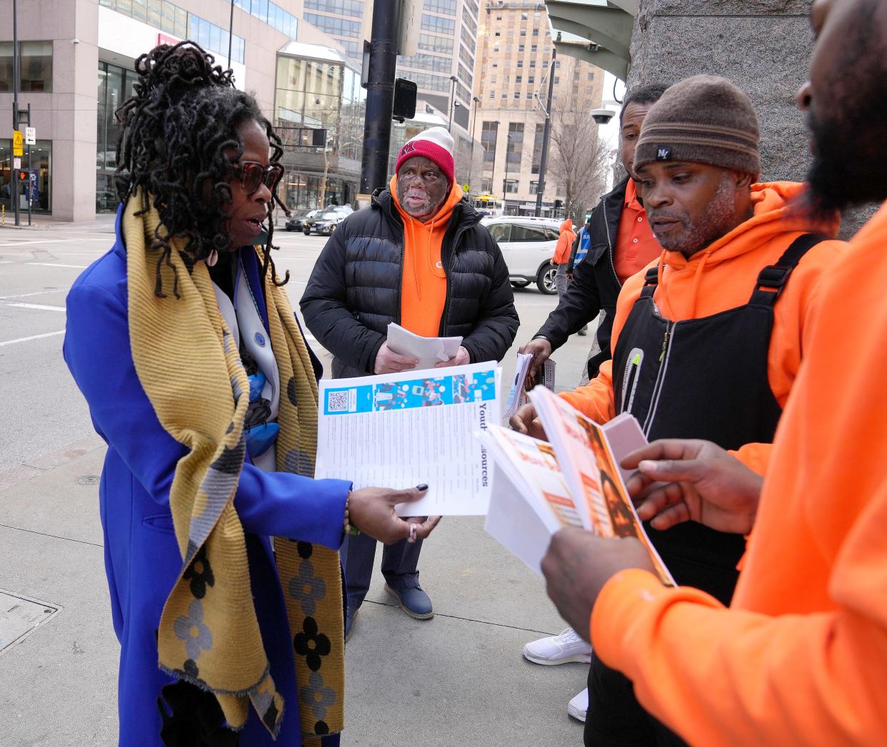 Community activist Iris Roley speaks with members of the Urban League's Community Partnering Center before handing out information to teens at Government Square. The outreach effort followed two two assaults committed by groups of teens that were captured by surveillance video.