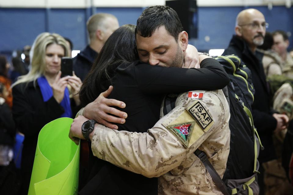 Corporal Cayer hugs his girlfriend Merrell after arriving from Afghanistan in Ottawa