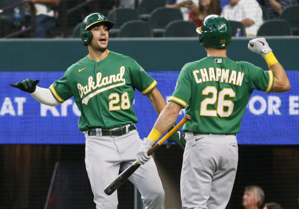 Oakland Athletics' Matt Olson prepares to body bump Matt Chapman after hitting his second solo home run of the game against the Texas Rangers during the sixth inning of a baseball game in Arlington, Texas, Sunday, July 11, 2021. (AP Photo/Ray Carlin)