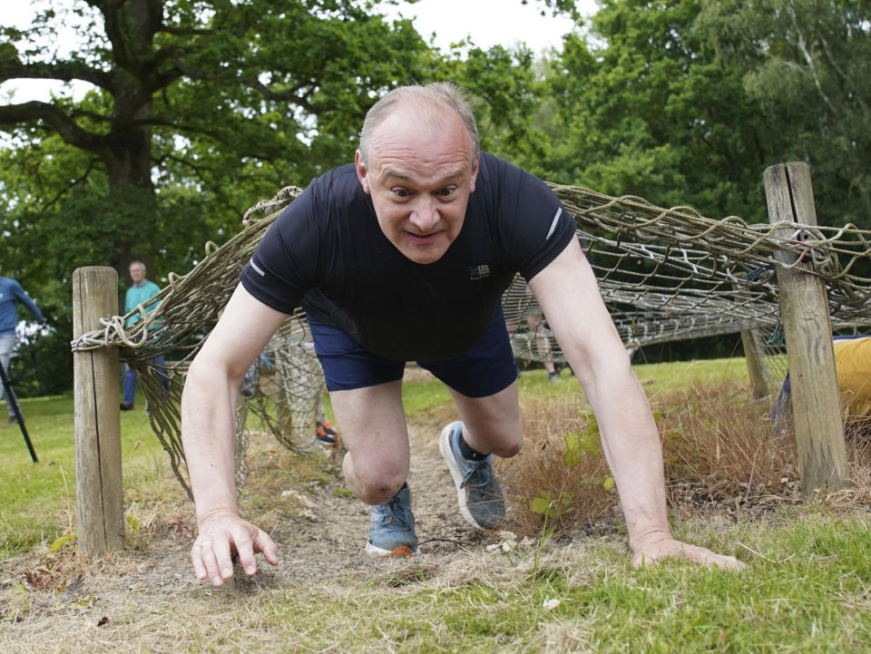 Britain's Liberal Democrats leader Ed Davey takes part in an assault course during a visit to Arena Pursuits in Wadhurst, Kent, England, Thursday, June 13, 2024, while on the general election campaign trail. (Gareth Fuller/PA via AP)