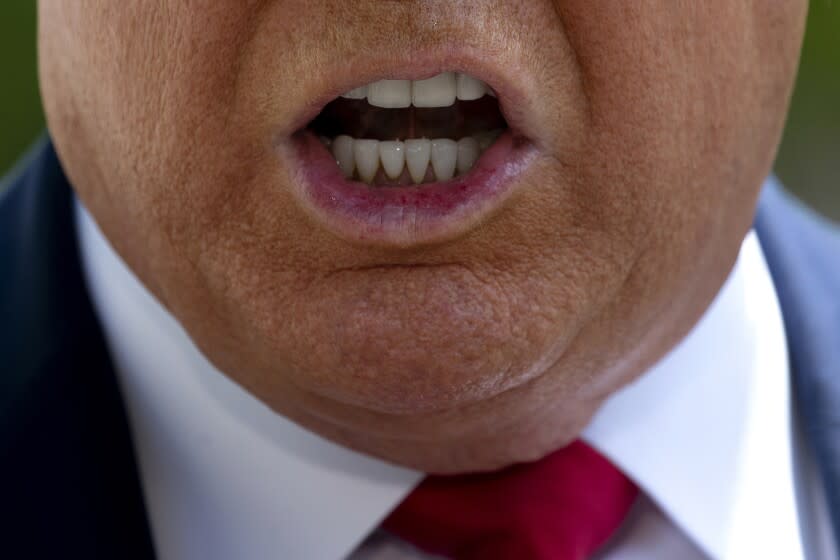 FILE - In this May 30, 2020, file photo, President Donald Trump speaks with members of the press on the South Lawn of the White House, in Washington. Reports of hateful and violent speech on Facebook poured in on the night of May 28 after President Donald Trump hit send on a social media post warning that looters who joined protests following Floyd's death last year would be shot, according to internal Facebook documents shared with The Associated Press. (AP Photo/Patrick Semansky, File)