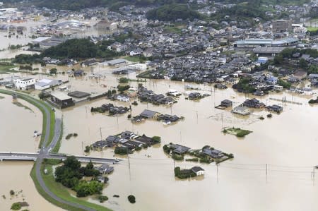 An aerial view shows submerged houses and facilities at a flooded area in Takeo, Japan