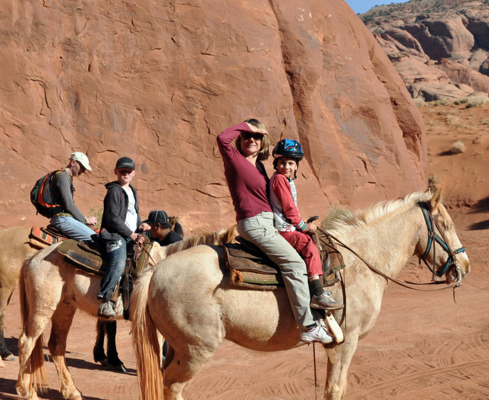 This undated image provided by the Navajo Tourism Department shows visitors riding horseback at Monument Valley Navajo Tribal Park in northeastern Arizona. An economic impact study and yearlong survey show spending by tourists on the Navajo Nation has increased by nearly one-third since 2002. (AP Photo/Navajo Tourism Department, Roberta John)