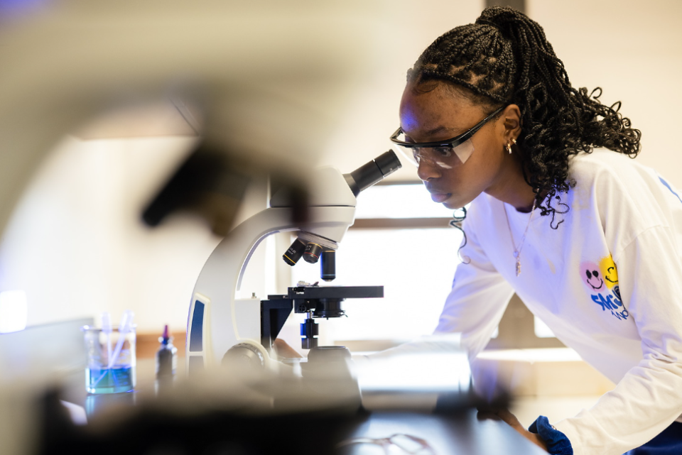 A University High School student uses an inverted microscope provided by a local hospital partner to conduct science research in a biology class. The school functions as a lab school through the University of Memphis in Memphis, Tenn.