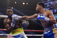 Shakur Stevenson hits Jeremiah Nakathila, of Namibia, in a WBO interim junior lightweight title fight Saturday, June 12, 2021, in Las Vegas. (AP Photo/John Locher)