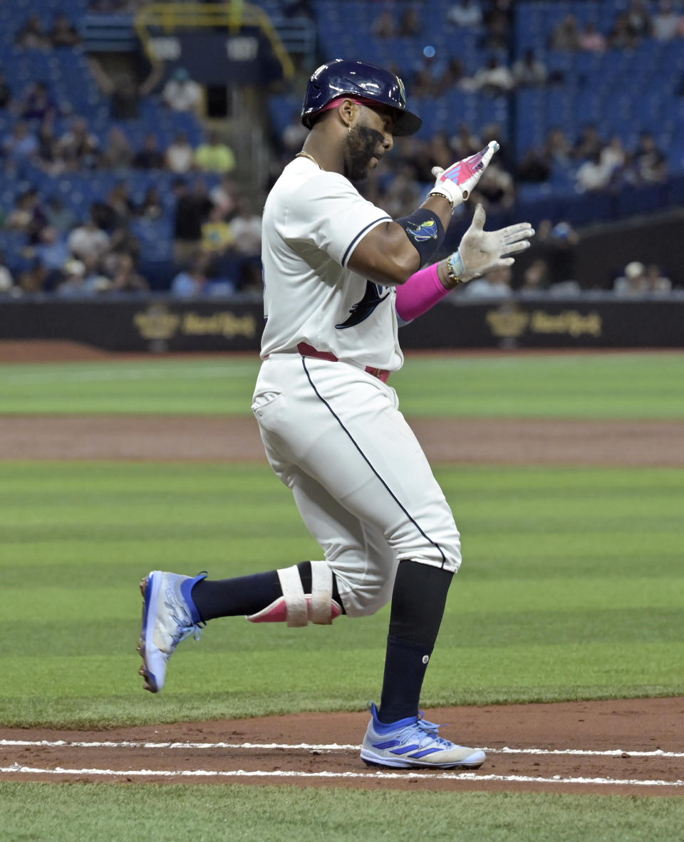 Tampa Bay Rays' Yandy Díaz claps as he reaches first base with a single to extend his hitting streak to 20 games, during the third inning of the team's baseball game against the Washington Nationals on Friday, June 28, 2024, in St. Petersburg, Fla. (AP Photo/Steve Nesius)