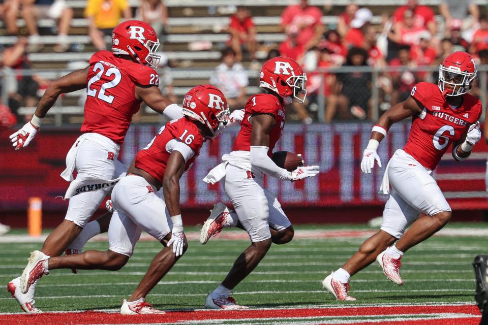 Sep 3, 2023; Piscataway, New Jersey, USA; Rutgers Scarlet Knights defensive back Robert Longerbeam (7) celebrates his interception with teammates during the second half against the Northwestern Wildcats at SHI Stadium. Mandatory Credit: Vincent Carchietta-USA TODAY Sports