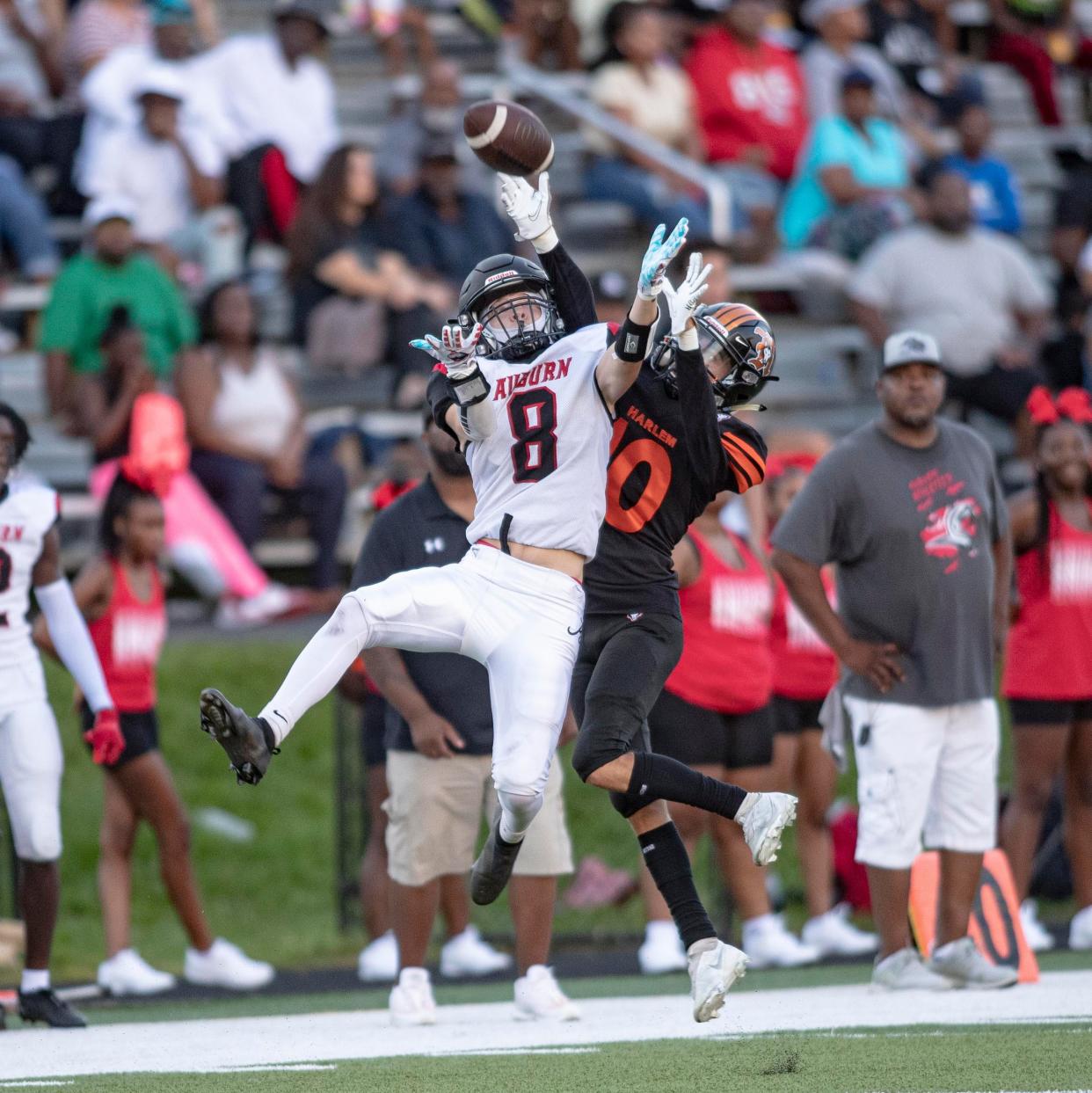 Auburn's Athavion Coleman catches the ball against Harlems Austin Pinkston on Saturday, Aug. 27, 2022, at Harlem High School in Machesney Park.