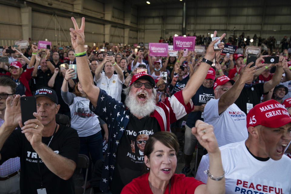 Supporters of President Donald Trump cheer as he arrives to speak during a campaign rally at Arnold Palmer Regional Airport, Thursday, Sept. 3, 2020, in Latrobe, Pa. (AP Photo/Evan Vucci)