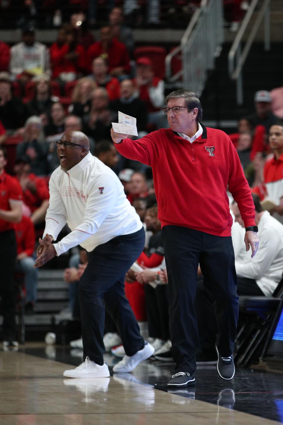 Texas Tech coach Mark Adams (right) and assistant Corey Williams shout instructions from the bench during the first half of a Big 12 Conference game Tuesday against No. 15 Iowa State inside United Supermarkets Arena. The No. 18 Red Raiders won 72-60.