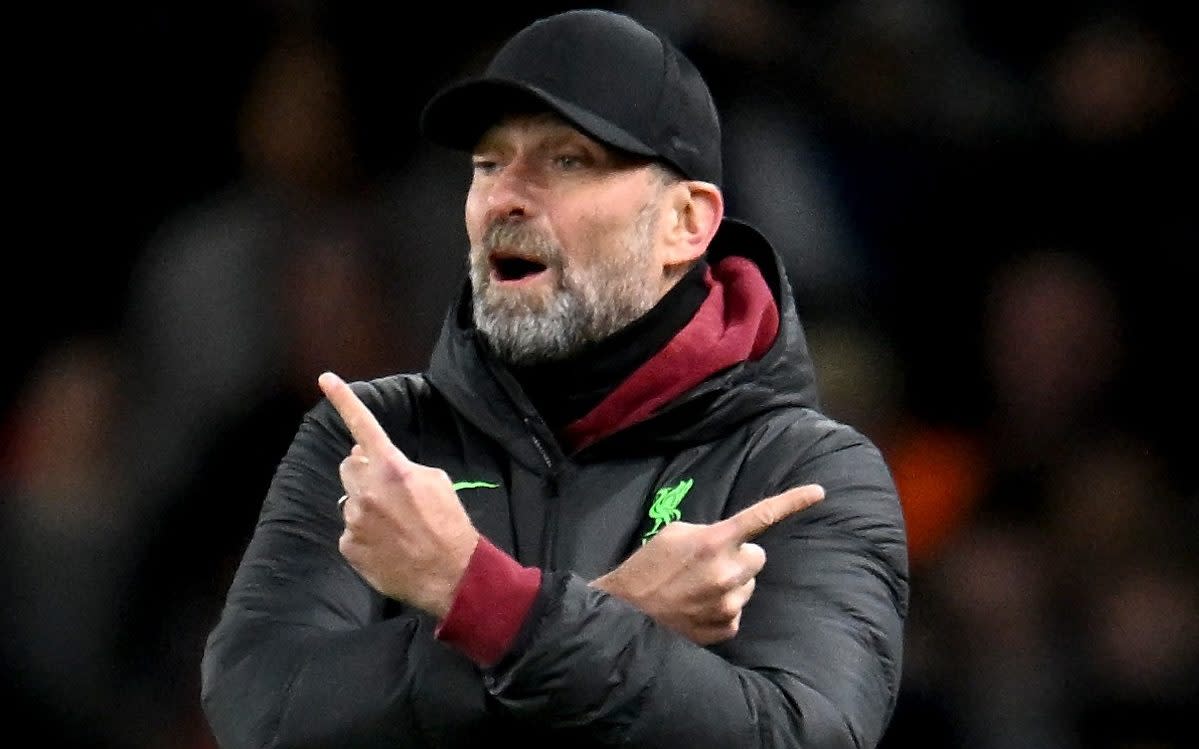 Jurgen Klopp gestures with pointed fingers and crossed arms during the FA Cup win at Arsenal