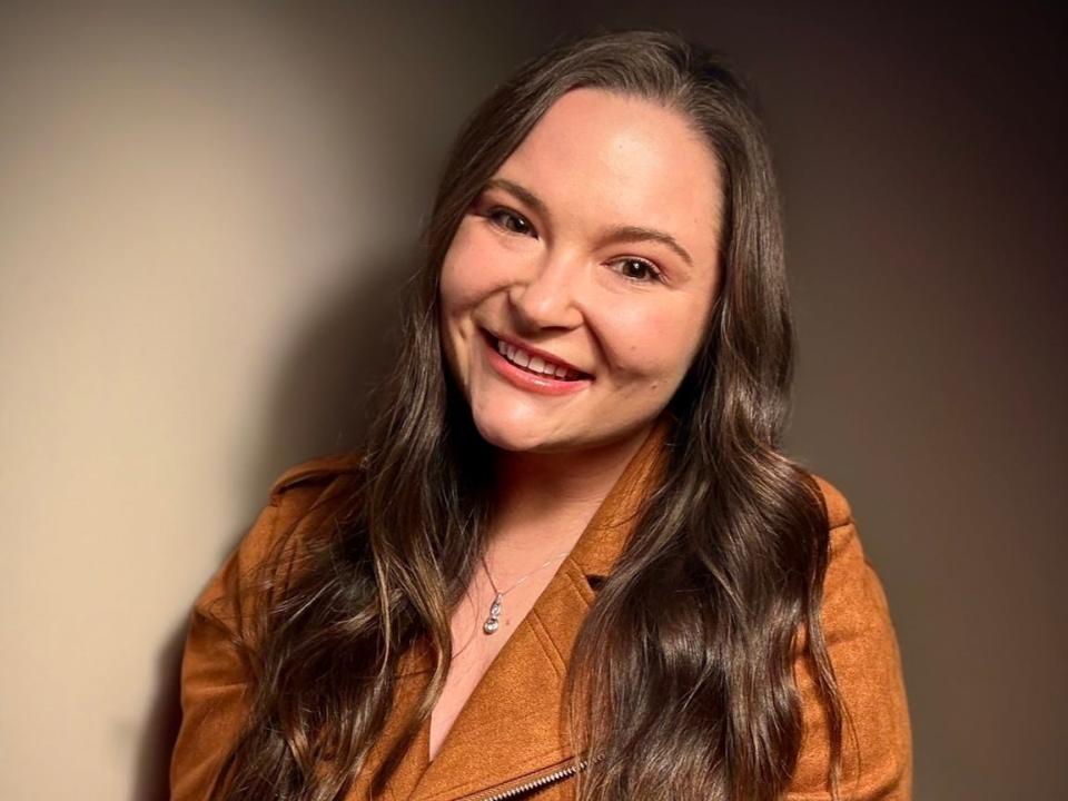 A professional headshot of a woman.