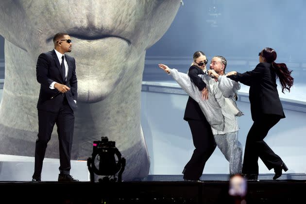 J Balvin, right, was playfully yanked from the stage by dancers. 