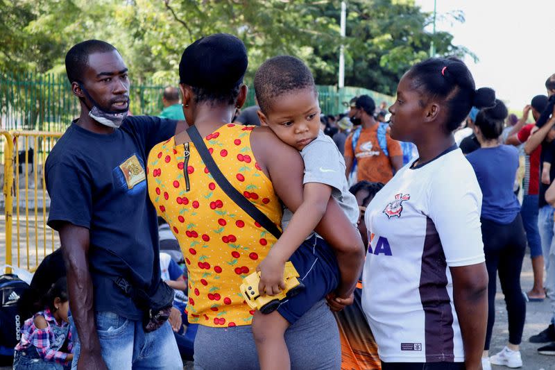 FILE PHOTO: Haitian migrants line up as they wait for a QR code to register their migratory situation, in Tapachula