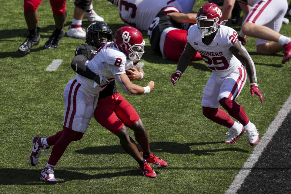 Oklahoma quarterback Dillon Gabriel (8) carries the ball for a touchdown against Cincinnati safety Bryon Threats, back, during the second half of an NCAA college football game, Saturday, Sept. 16, 2023, in Cincinnati. (AP Photo/Aaron Doster)