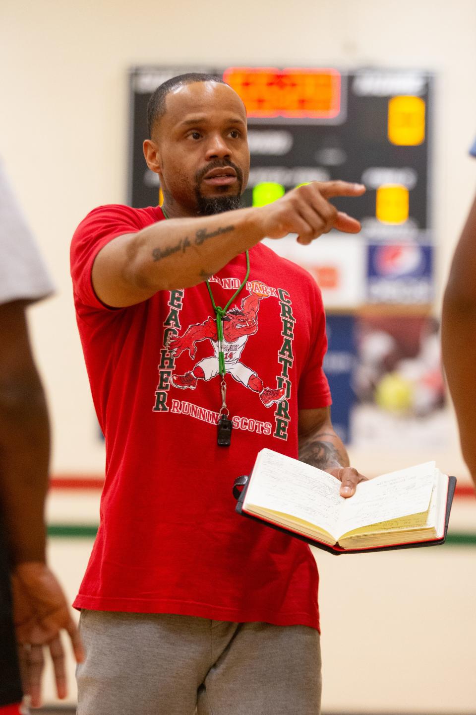 Highland Park coach Mike Williams gives instructions for his staff before starting drills at the school's south gym last week.