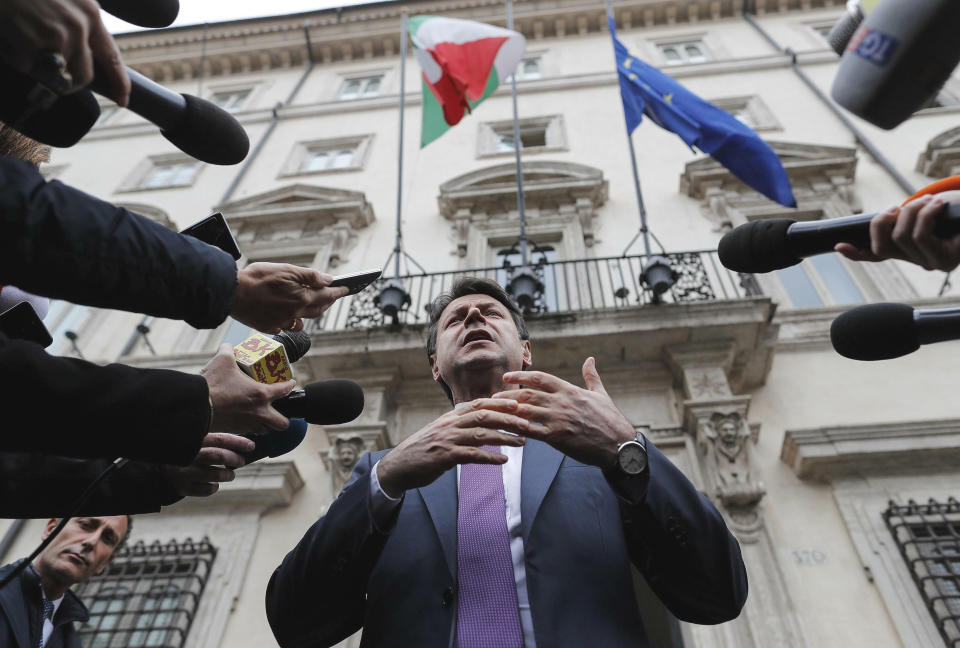Italian premier Giuseppe Conte talks to journalists outside Chigi Palace's Premier office, in Rome Tuesday, March 5, 2019. Intent on his government’s survival, Premier Giuseppe Conte says the coalition will let “national” interests determine if an Alpine rail tunnel should be built. The populist government’s main partner, the 5-Star Movement, fiercely opposes the high-speed TAV rail tunnel, which is meant to speed travel between France and Italy. (Riccardo Antimiani/ANSA via AP)