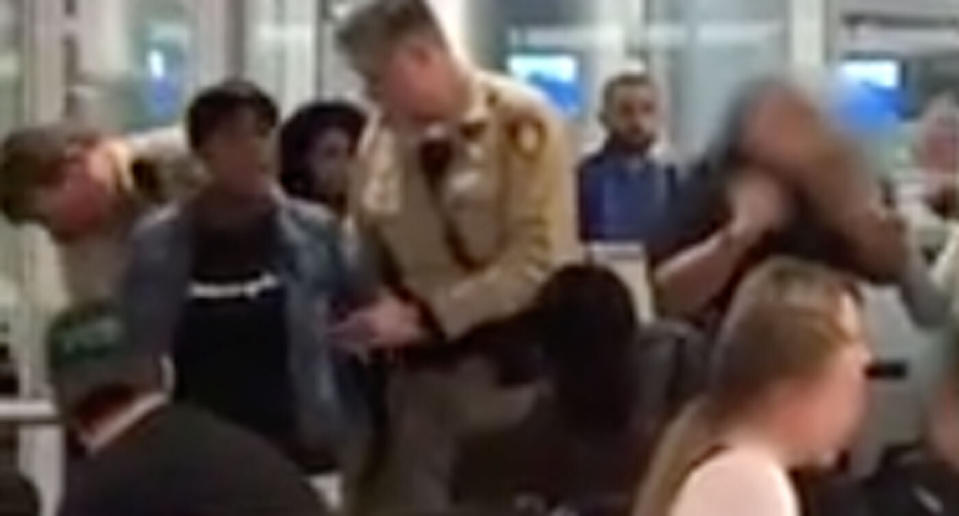 Ms Swinney in the terminal after being removed from the flight. The airline claims staff apologised to her and offered a different seat. She disputes this. Source: Storyful