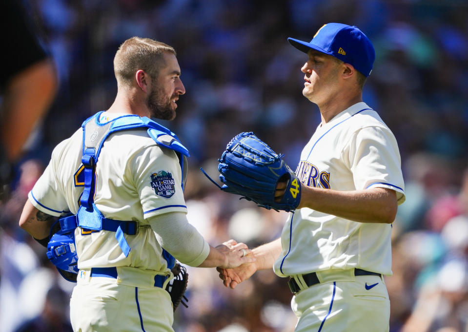 Seattle Mariners catcher Tom Murphy greets relief pitcher Paul Sewald after Sewald earned the save in a 7-6 win against the Tampa Bay Rays in a baseball game, Sunday, July 2, 2023, in Seattle. (AP Photo/Lindsey Wasson)