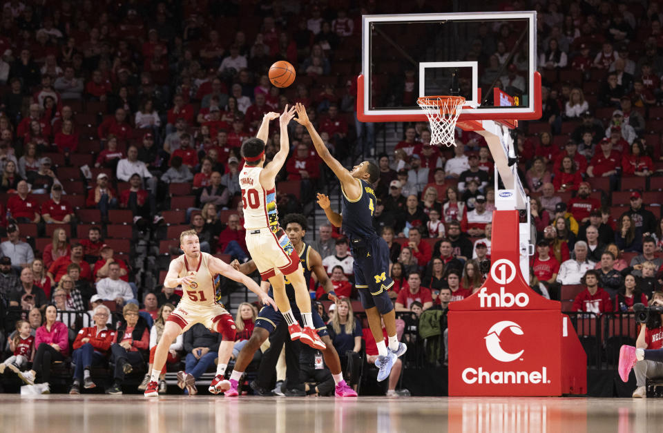 Nebraska's Keisei Tominaga (30) shoots against Michigan's Nimari Burnett (4) during the second half of an NCAA college basketball game Saturday, Feb. 10, 2024, in Lincoln, Neb. (AP Photo/Rebecca S. Gratz)