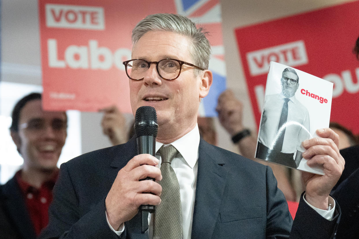 Labour Party leader Sir Keir Starmer holds a copy of his party's election manifesto whilst campaigning in Halesowen in the West Midlands for this year's General Election on July 4. Picture date: Thursday June 13, 2024. (Photo by Stefan Rousseau/PA Images via Getty Images)