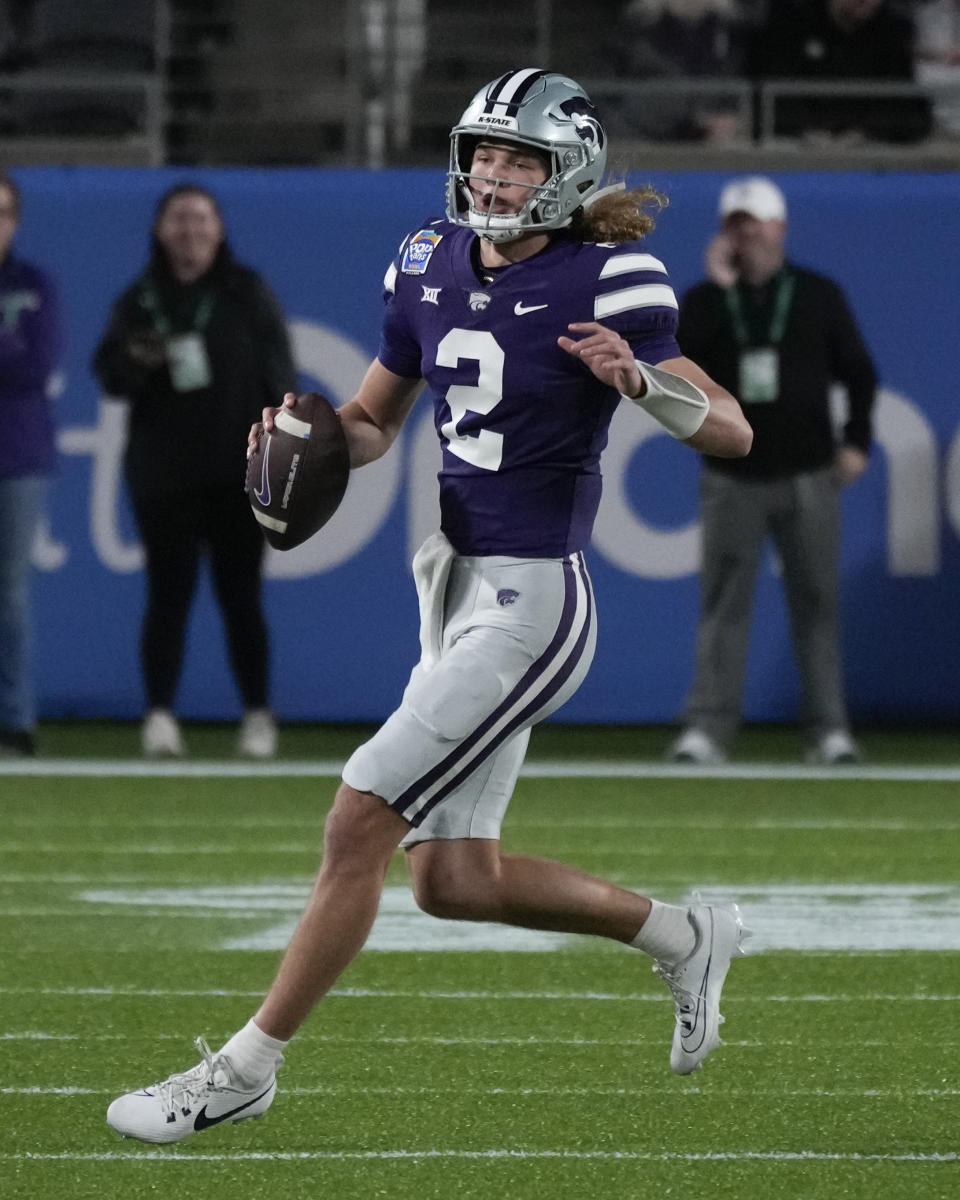 Kansas State quarterback Avery Johnson (2) looks for a receiver as he scrambles from the pocket during the first half of the Pop-Tarts Bowl NCAA college football game against North Carolina State, Thursday, Dec. 28, 2023, in Orlando, Fla. (AP Photo/John Raoux)