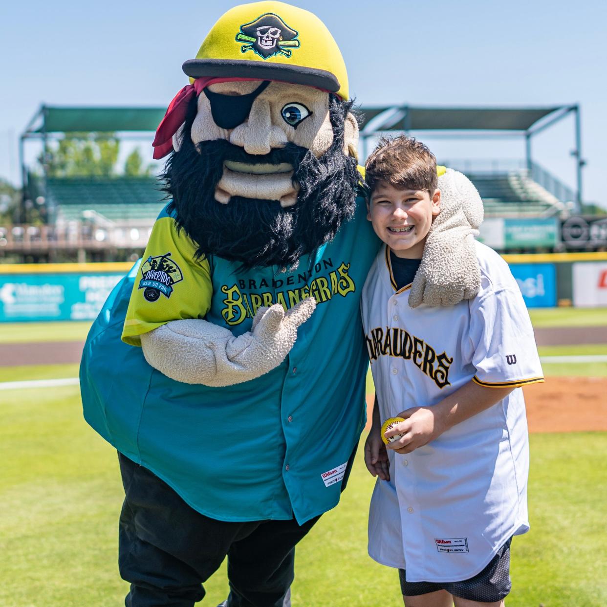 Connor Longò, aka “Mr. One Million,” hugs it out with Mr. Marauder after he became the 1,000,000th fan through the ballpark gates since the Bradenton Marauders began playing in 2010.