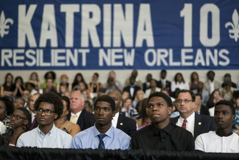 People listen to US President Barack Obama during a roundtable discussion at the Andrew P. Sanchez Community Center on August 27, 2015 in New Orleans, Louisiana