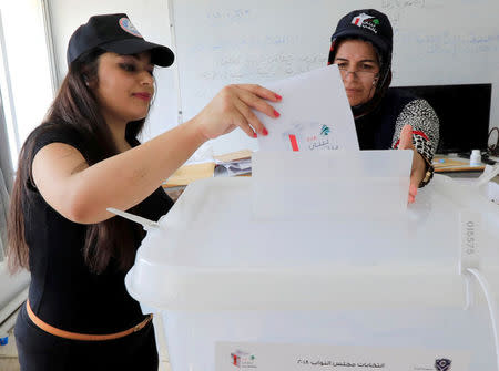 A woman casts her vote at a polling station during the parliamentary election, in Aley, Lebanon, May 6, 2018. REUTERS/ Jamal Saidi