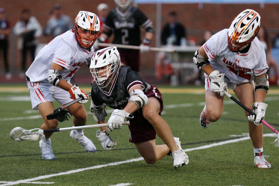 Scarsdale's Colby Baldwin (1) gets between Mamaroneck's Will Schlamme (12) and Brady Auker (15) during the Section 1 Class A championship game at Lakeland High School in Shrub Oak May 27, 2022. Scarsdale won the game 12-7.
