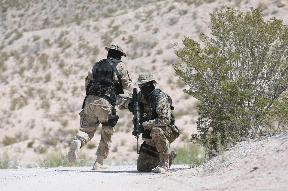 "Viper" and "Stinger" of the United Constitutional Patriots New Mexico militia patrol near border fencing near Sunland Park, New Mexico, next to El Paso in 2019. The militia group was eventually kicked out of its camp site and its leader convicted and sentenced on a federal firearms charge.