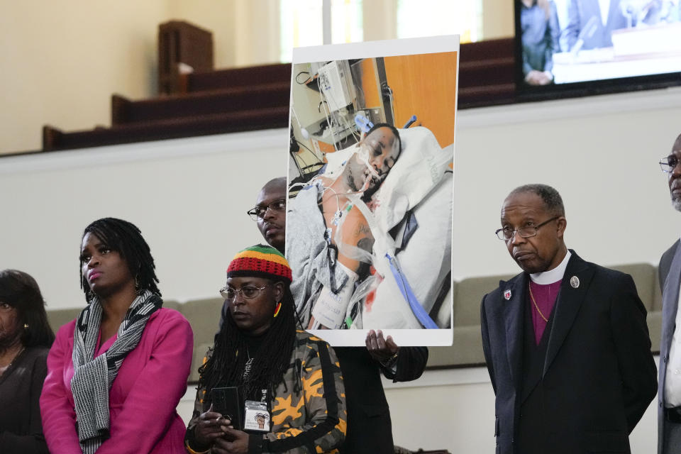 Family members and supporters hold a photograph of Tyre Nichols, who died after being beaten by Memphis police officers, at a news conference with civil rights Attorney Ben Crump in Memphis, Tenn., Monday, Jan. 23, 2023. (AP Photo/Gerald Herbert)