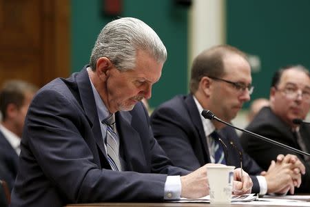 Takata Executive Vice President Kevin Kennedy (L) lowers his head as he appears at a hearing of a House Energy and Commerce Subcommittee on the Takata airbag recall, on Capitol Hill in Washington June 2, 2015. REUTERS/Gary Cameron